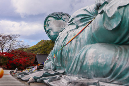 Serene Giant Reclining Buddha Statue with Autumn Scenery in Japan