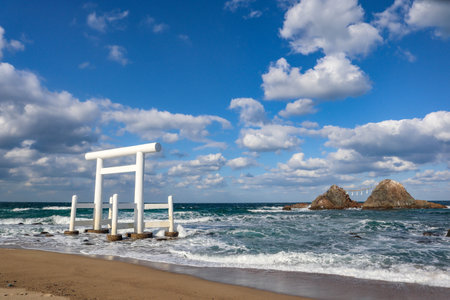 Sacred Shinto Shrine Gate by the Sea with Wedded Rocks, Fukuoka Japanの写真素材