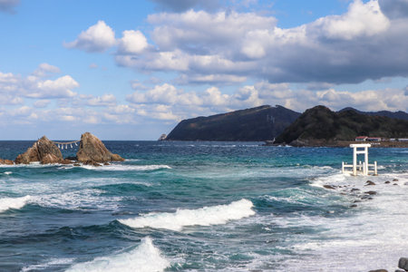 Sacred Shinto Shrine Gate by the Sea with Wedded Rocks, Fukuoka Japanの写真素材
