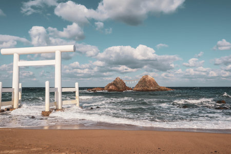 Sacred Shinto Shrine Gate by the Sea with Wedded Rocks, Fukuoka Japanの写真素材