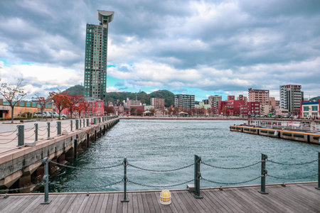 Scenic Urban Waterfront Pier in Kitakyushu, Japan with Modern Buildings and Harbor Viewの写真素材