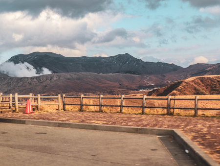 Scenic View of Mountain Landscape with Sun Rays and Wooden Fence at Sunsetの写真素材