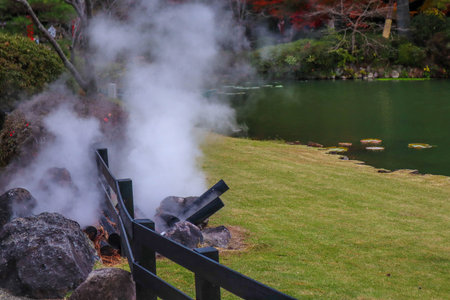 The garden in Umi Jigoku or sea hell featuring a pond with blue hot stream water.