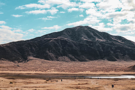 Scenic Landscape of Mount Aso with Vast Grassland under Cloudy Sky in Kumamoto, Japanの写真素材