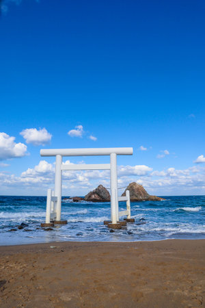 Sacred Meotoiwa Rocks and Ocean View with Japanese Shinto Torii Gate on the Beachの写真素材