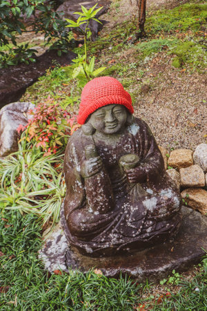 Weathered Jizo Guardian Deity in Japanese Temple Garden.