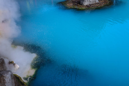 Tranquil Japanese Onsen Pool with Steam, Nature and Red Fence.の写真素材