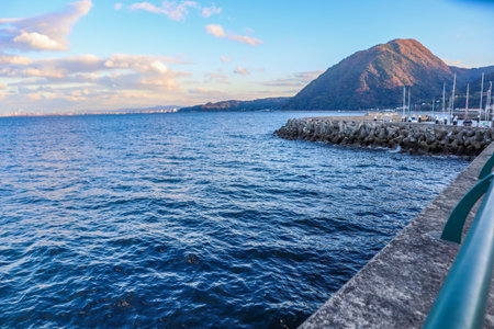 Coastal Seascape with Tetrapods, Pier and Distant City View.の写真素材