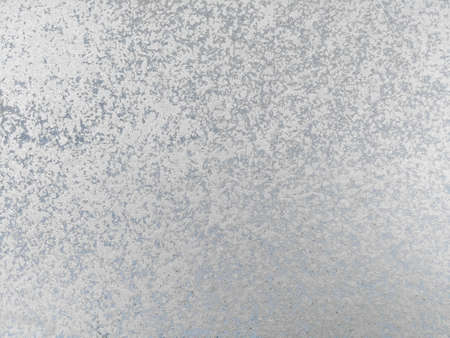 Old silver paint smears close-up on smooth wall surface. Abstract stained grunge background
