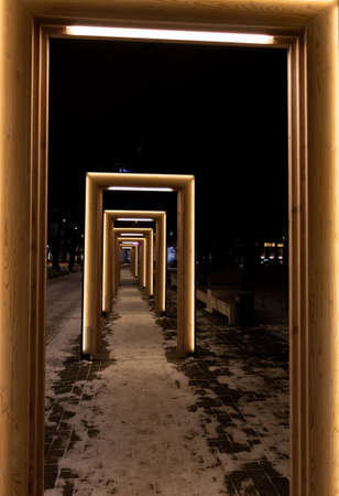 Tallinn, Estonia - March 12, 2019: Modern art installation with glowing door frames in the night