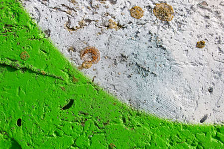 Painted rough concrete wall with cracks, green and white colorの写真素材
