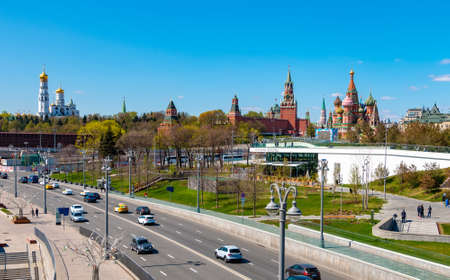 Moscow, Russia - April 29, 2019: Embankment and city traffic near Zaryadye park, Kremlin towers and St Basil Cathedral in sunny dayのeditorial素材