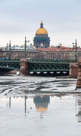 Saint Petersburg, Russia - February 24, 2019: Palace bridge and Isaac cathedral reflect in Neva river on a spring dayのeditorial素材