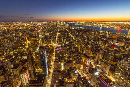 Illuminated Skyline of Manhattan, New York in the evening twilight after sunset. United States of...