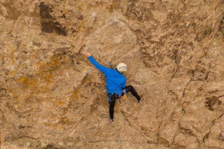 Man Climber Rock Climbing. Cliffs in Tamgaly Tas, Kazakhstan. Aerial View.