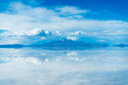 Uyuni Salt Flats. Altiplano, Bolivia. Rainy Season. Tunupa Volcano. Clouds Reflection on Water in...