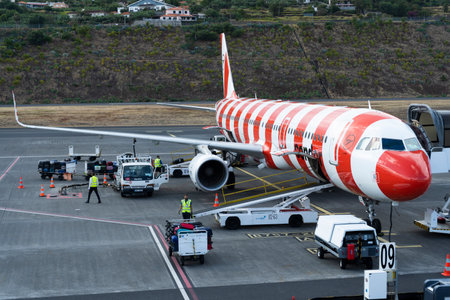 MADEIRA - JUNE 6, 2024: Condor Airlines Airplane Luggage Unloading at Airport.のeditorial素材
