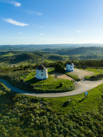 Old Windmills in Green Montejunto Mountains on Sunny Day. Portugal. Aerial Viewの写真素材