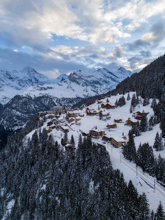 Murren Town and Mountains in Winter Evening. Swiss Alps. Switzerland. Aerial View