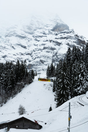 Train from Grutschalp to Murren and Mountains on Cloudy Winter Day. Swiss Alps. Switzerlandの写真素材