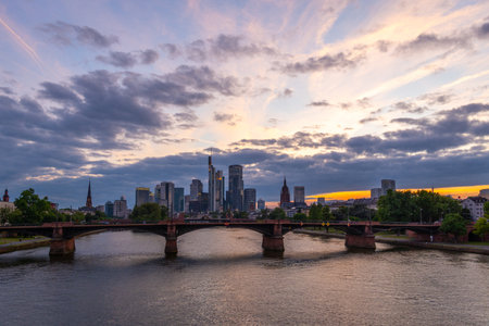 Illuminated Frankfurt City Downtown, Ignatz Bubis Bridge and Main River at Summer Sunset. Hesse, Germanyの写真素材