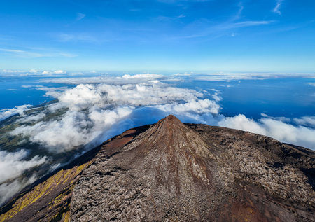 Panorama of Piquinho, Top of Mount Pico Stratovolcano, Crater and Clouds. Shadow of Mountain. Atlantic Ocean. Pico Island, Azores. Portugal. Aerial View