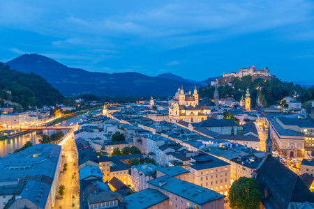 Illuminated Salzburg Old Town and Hohensalzburg Fortress at Evening Twilight. Salzach River. Austria. Blue Hourの写真素材