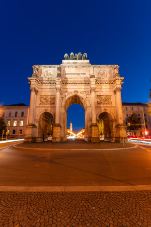 Illuminated Siegestor Memorial Arch at Night and Car Light Trails. Munich, Bavaria, Germanyの写真素材
