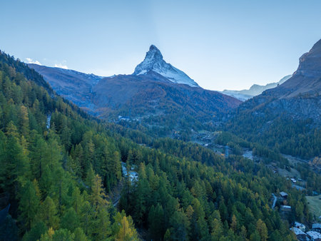 Matterhorn Mountain and Green Larches in Autumn in Evening. Aerial View. Swiss Alps. Zermatt, Valais, Switzerland. Wide Shotの写真素材
