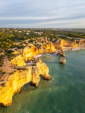 Marinha Beach, Arch, Sea Stacks, Cliffs and Atlantic Ocean on Sunny Morning. Aerial Shot. Algarve, Portugalの写真素材