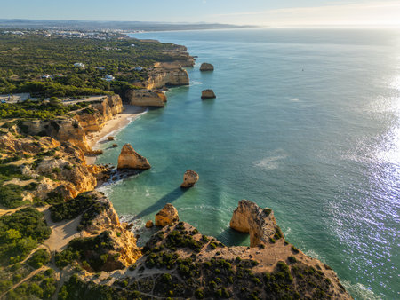 Marinha Beach, Cliffs, Coastline and Atlantic Ocean on Sunny Day. Green Trees. Aerial View. Algarve, Portugalの写真素材