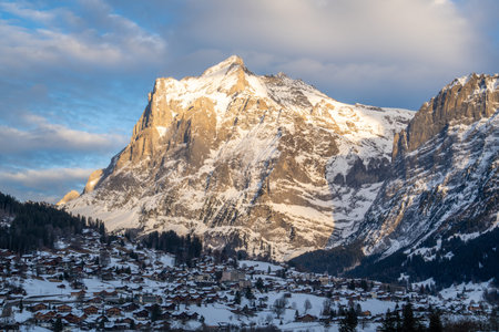 Wetterhorn Mountain and Grindelwald Town in Winter Evening. Wooden Chalets and Swiss Alps. Switzerlandの写真素材