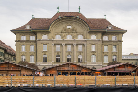 BERN, SWITZERLAND - FEBRUARY 4, 2026: Headquarters of Swiss National Bank and Ice Rink with People...