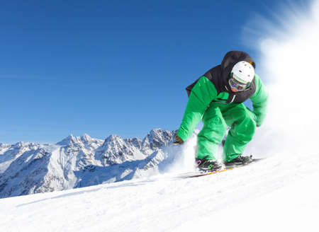downhill with snowboards in fresh snowの写真素材