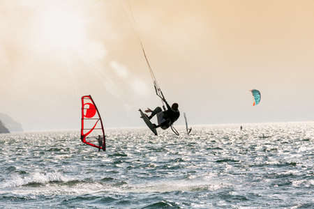 kite surfer in action at sunsetの写真素材