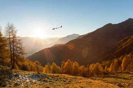 glider in flight on autumn landscapeの写真素材