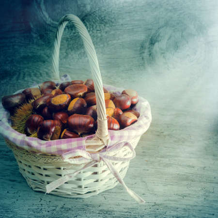 wicker basket with freshly picked chestnutsの写真素材
