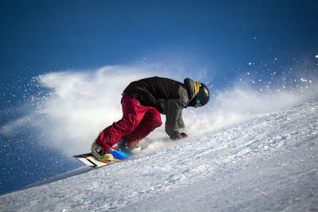 snowboarders in action on a snowy trackの写真素材