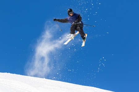 acrobatic jump on skis in clear skyの写真素材