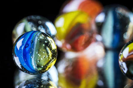 glass marbles on glass - close upの写真素材