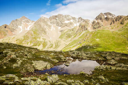 Alpine panorama with natural pondの写真素材