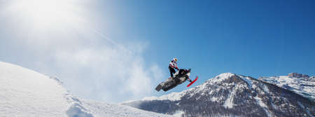 jump with snowmobile in fresh snowの写真素材