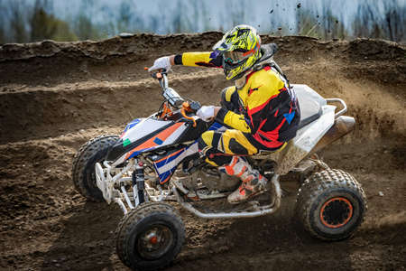 race with quads on dirt roadsの写真素材