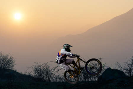 biker at sunset - soaring with mtbの写真素材