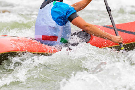 engaged athlete downhill with canoeの写真素材