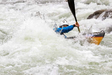 engaged athlete downhill with canoeの写真素材