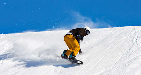 Snowboarder in action on the track with fresh snowの写真素材