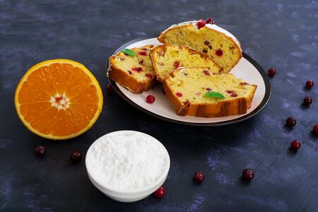 Cupcake with orange and cranberries on dark purple backgroundの写真素材