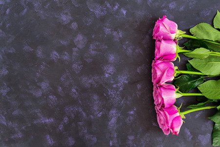 Bouquet of purple roses on a dark background. Top viewの写真素材