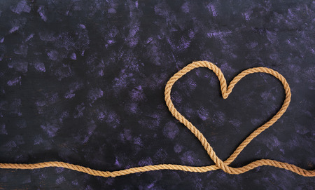 Heart shape made with rope on dark backgroundの写真素材
